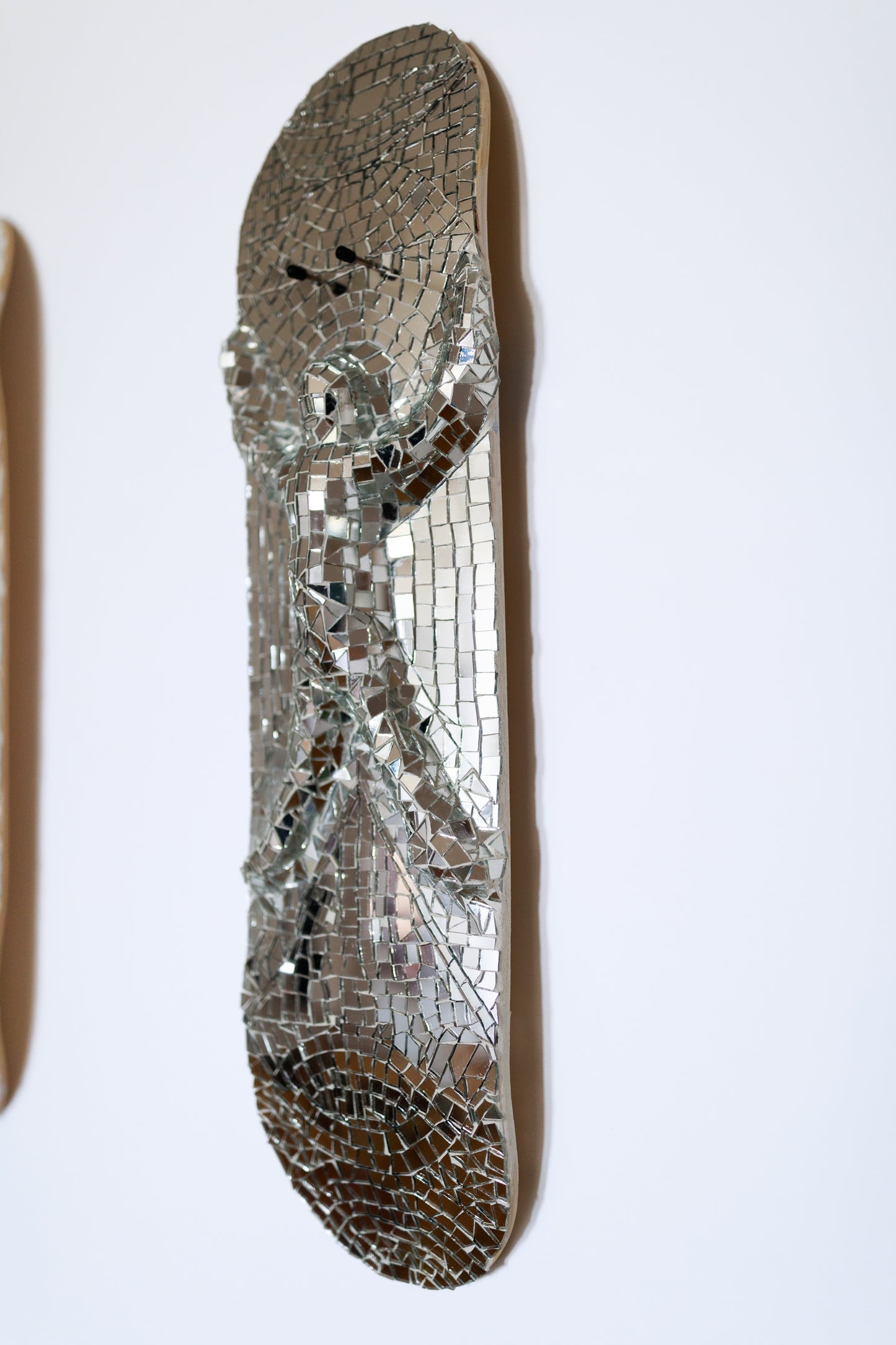 Gauli Mora, The Body, sculpture, 2024, glass on skate deck, 30x8"