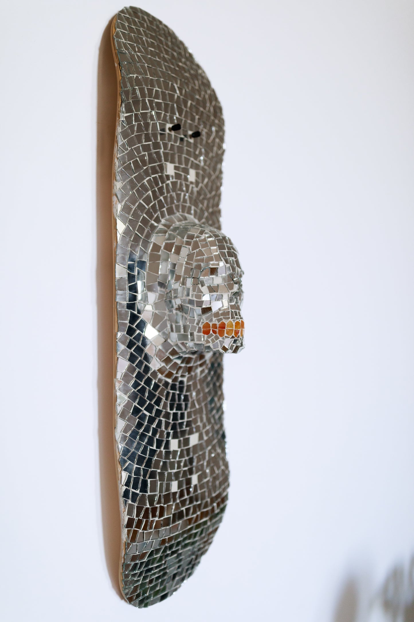 Gauli Mora, The Death, sculpture, 2023, glass on skate deck, 30x8"